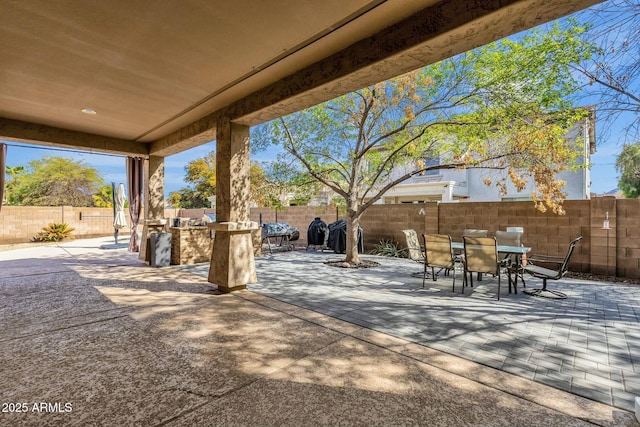 view of patio featuring a fenced backyard and outdoor dining space