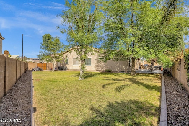 view of yard with a fenced backyard