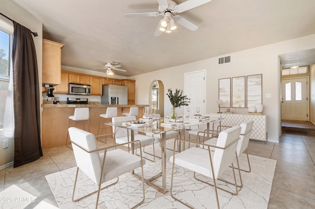 dining area with light tile patterned flooring and ceiling fan