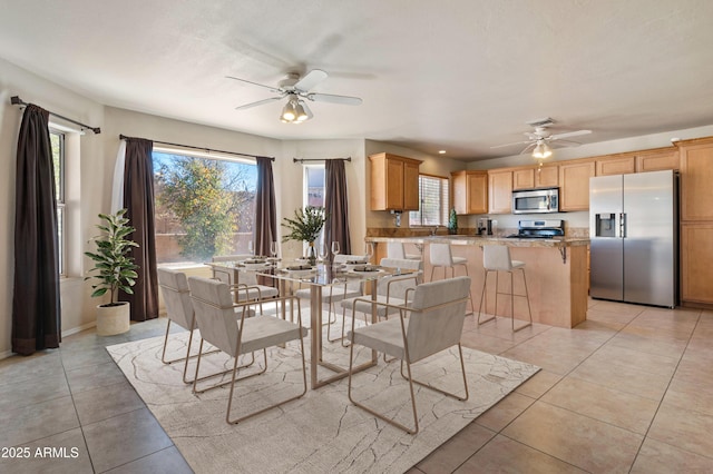 tiled dining room featuring ceiling fan