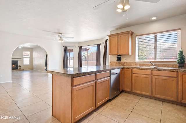 kitchen with ceiling fan, dishwasher, sink, and light tile patterned floors