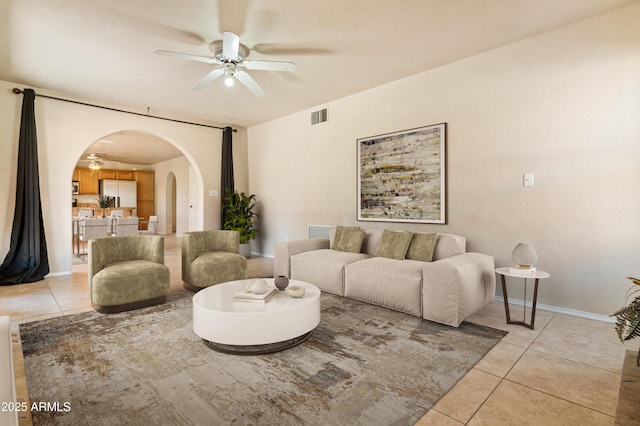 living room featuring light tile patterned flooring and ceiling fan