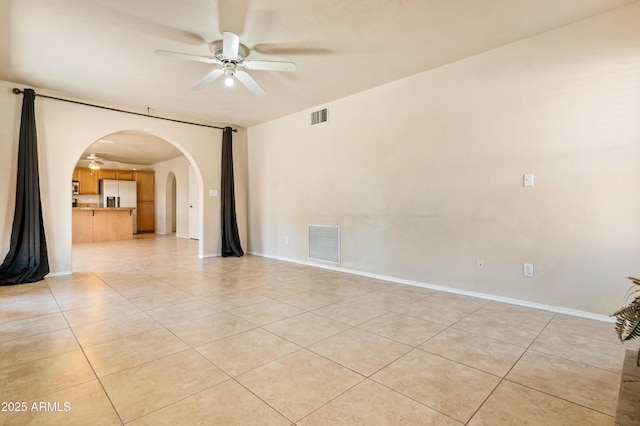 tiled empty room featuring ceiling fan