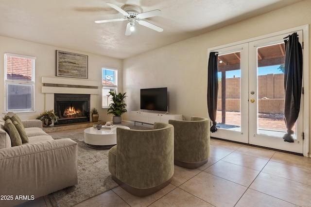 tiled living room with french doors and ceiling fan