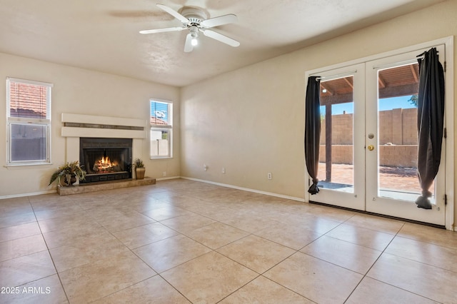 unfurnished living room with french doors, ceiling fan, and light tile patterned flooring