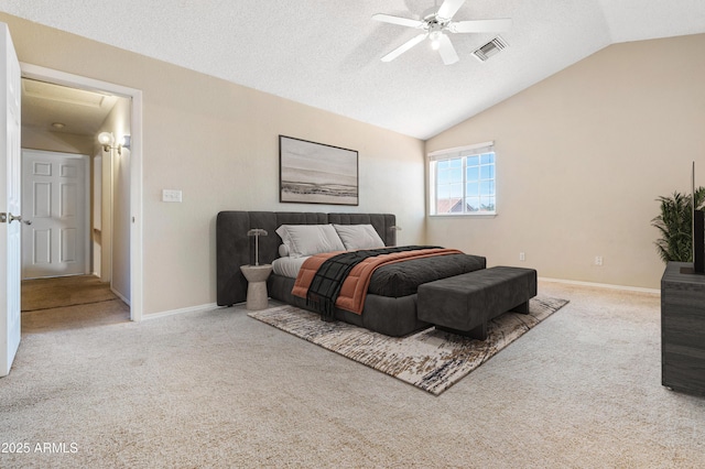 carpeted bedroom featuring vaulted ceiling, a textured ceiling, and ceiling fan