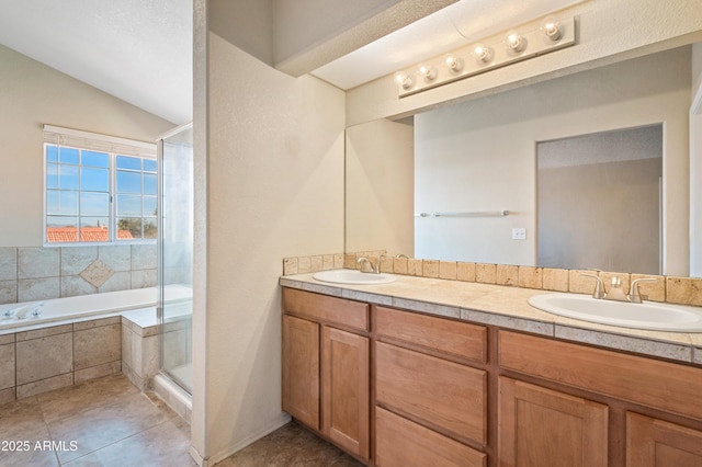 bathroom featuring independent shower and bath, vanity, lofted ceiling, and tile patterned flooring