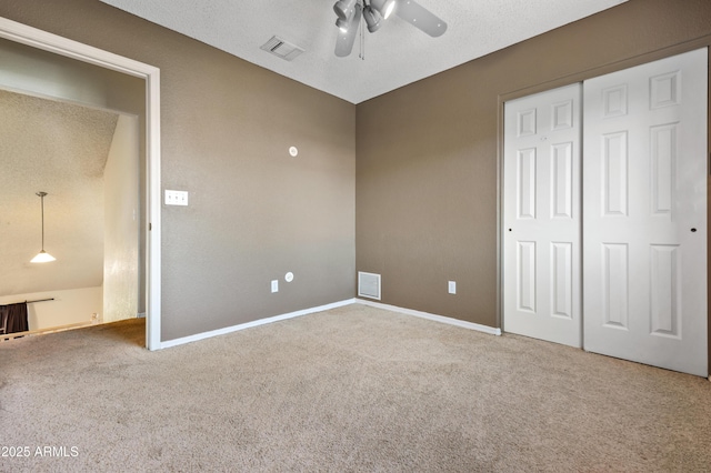 unfurnished bedroom with carpet flooring, ceiling fan, and a closet