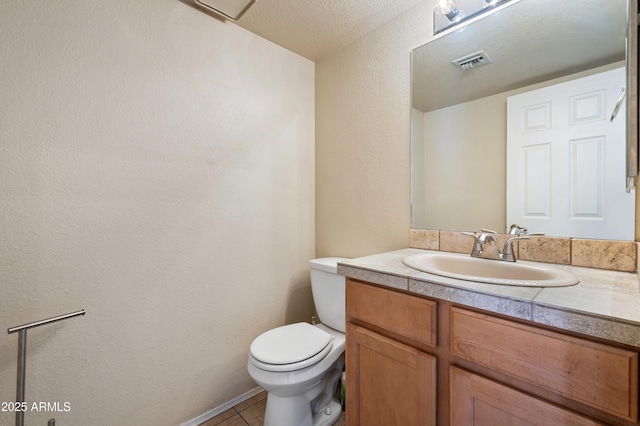 bathroom with tile patterned floors, vanity, and toilet