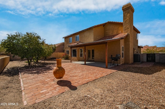 rear view of property featuring french doors and a patio area