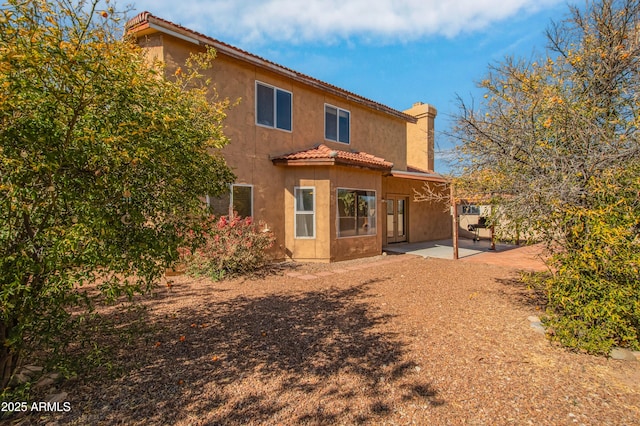 back of house with a patio