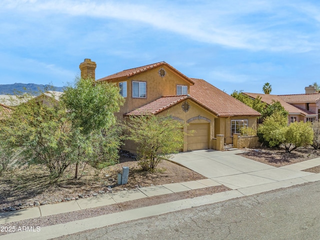 view of front facade with a mountain view and a garage