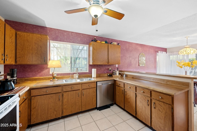 kitchen with a sink, stainless steel dishwasher, a peninsula, and brown cabinetry