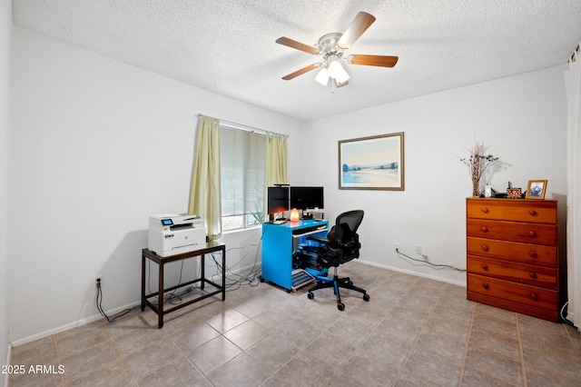 office space featuring a textured ceiling, baseboards, and ceiling fan