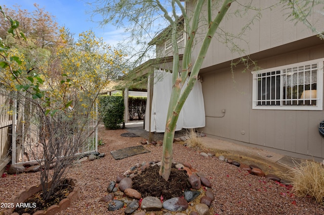 view of side of property featuring fence