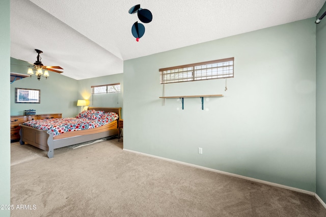 bedroom with a textured ceiling, baseboards, lofted ceiling, and carpet