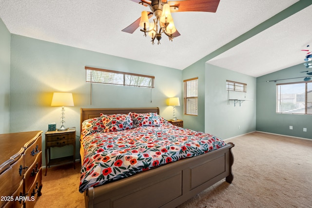 bedroom with baseboards, lofted ceiling, ceiling fan, a textured ceiling, and carpet flooring