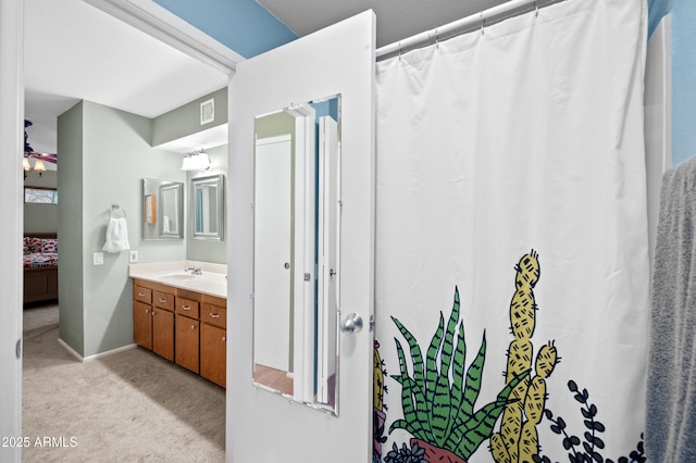 ensuite bathroom with vanity, a shower with shower curtain, a ceiling fan, visible vents, and ensuite bath