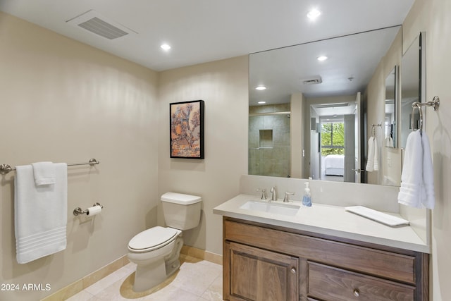 bathroom featuring tile patterned flooring, vanity, toilet, and an enclosed shower