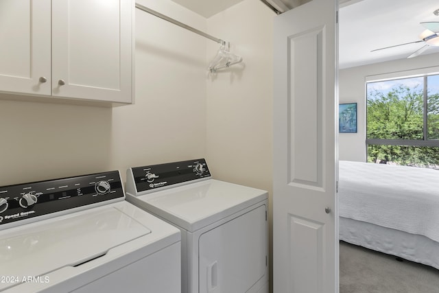 laundry area featuring cabinets, light colored carpet, ceiling fan, and washing machine and clothes dryer