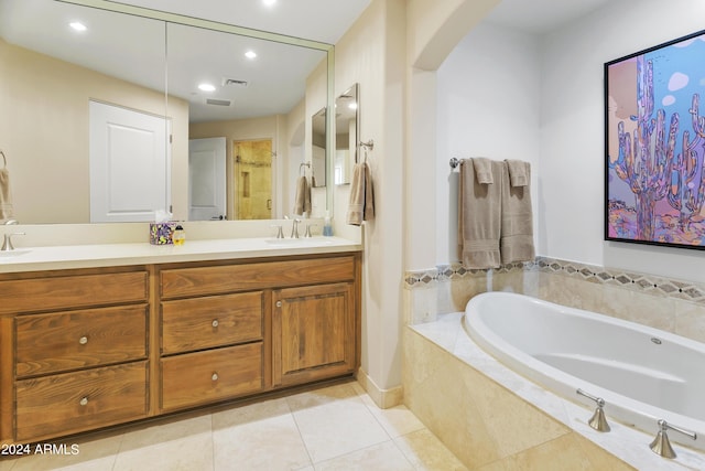 bathroom featuring tile patterned flooring, vanity, and shower with separate bathtub