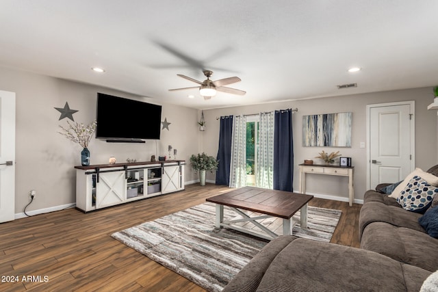 living room featuring hardwood / wood-style flooring and ceiling fan