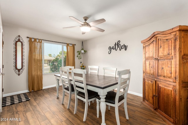 dining area with ceiling fan and dark hardwood / wood-style flooring