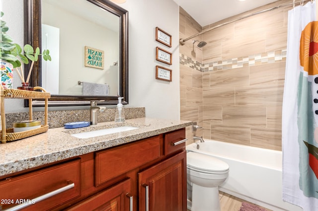 full bathroom featuring shower / bath combo with shower curtain, vanity, and toilet