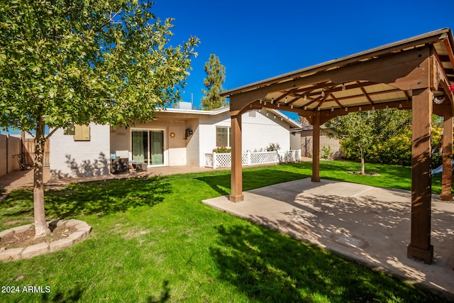 rear view of house featuring a gazebo, a yard, and a patio