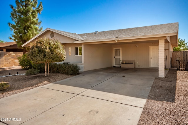 single story home featuring a carport