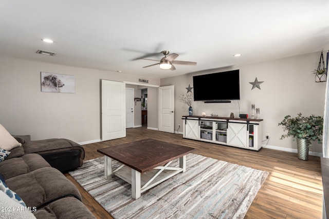 living room with hardwood / wood-style floors and ceiling fan