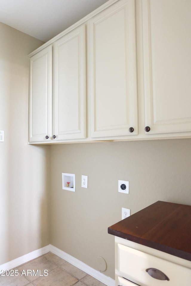 laundry room featuring cabinet space, electric dryer hookup, baseboards, and washer hookup