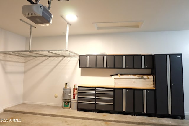 garage featuring baseboards and a garage door opener