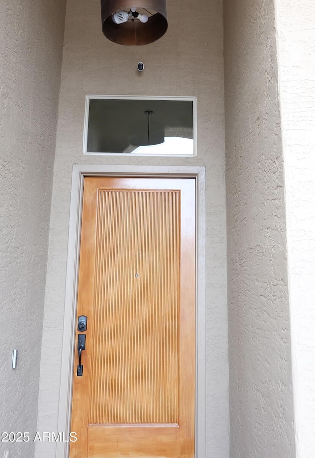 doorway to property with stucco siding