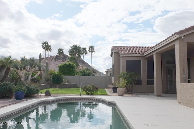 view of swimming pool featuring a fenced in pool, a patio, a lawn, and a fenced backyard