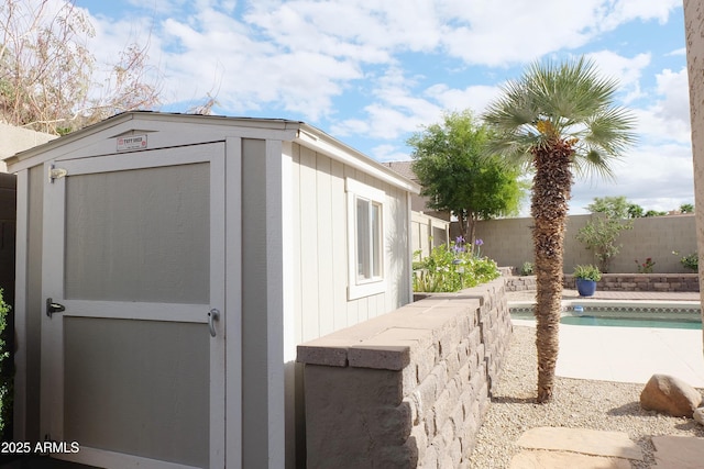 view of shed featuring a fenced in pool and a fenced backyard