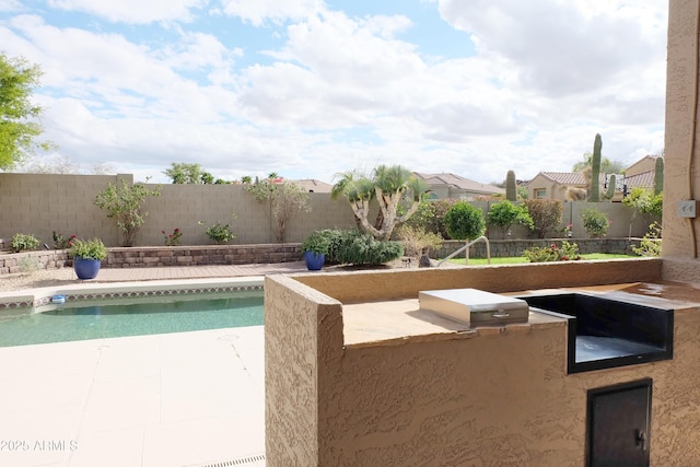 view of pool featuring grilling area, a fenced in pool, a fenced backyard, a patio area, and area for grilling