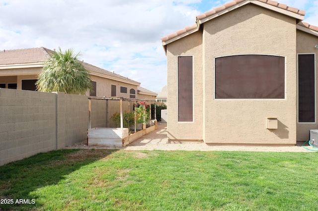 exterior space featuring a vegetable garden and a fenced backyard