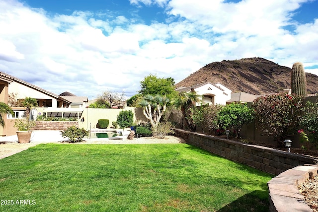 view of yard with a mountain view and a fenced backyard