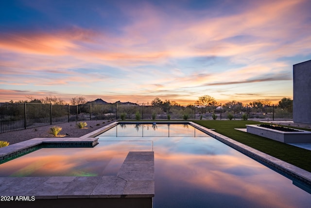 view of pool at dusk