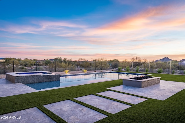34749 N 83rd Way, Scottsdale, AZ 85266 - pool at dusk featuring an outdoor fire pit, an in ground hot tub, and a lawn