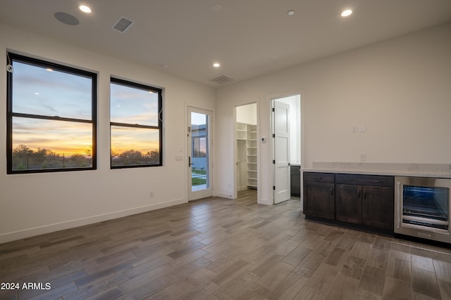 34749 N 83rd Way, Scottsdale, AZ 85266 - unfurnished living room with dark hardwood / wood-style flooring and wine cooler