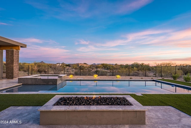 34749 N 83rd Way, Scottsdale, AZ 85266 - pool at dusk with an in ground hot tub, a fire pit, a yard, and a patio