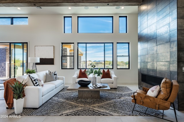 34749 N 83rd Way, Scottsdale, AZ 85266 - tiled living room featuring tile walls, a fireplace, and a high ceiling