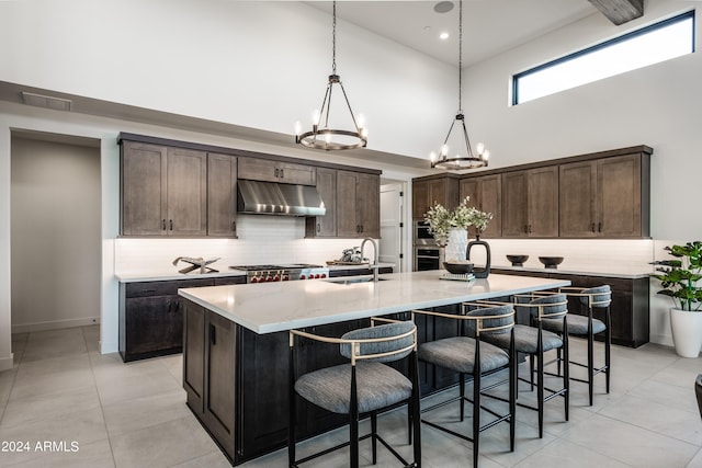 34749 N 83rd Way, Scottsdale, AZ 85266 - kitchen featuring a high ceiling, an inviting chandelier, sink, an island with sink, and pendant lighting