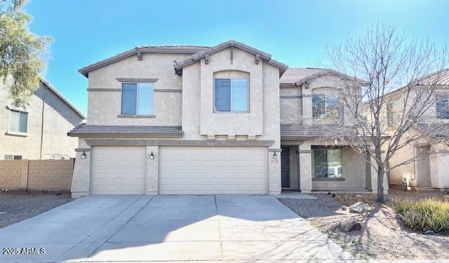 view of front of property with a garage, driveway, fence, and stucco siding