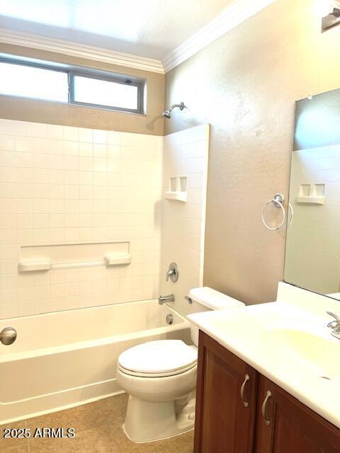 bathroom with tile patterned flooring, toilet, vanity, shower / bathing tub combination, and crown molding