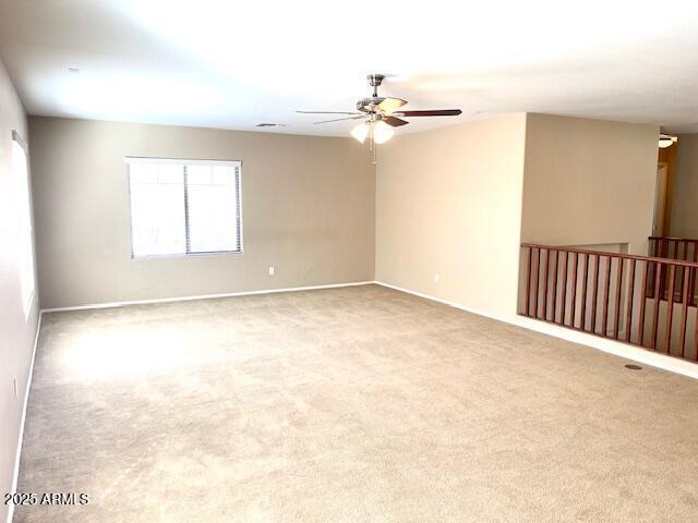 empty room with light carpet and ceiling fan