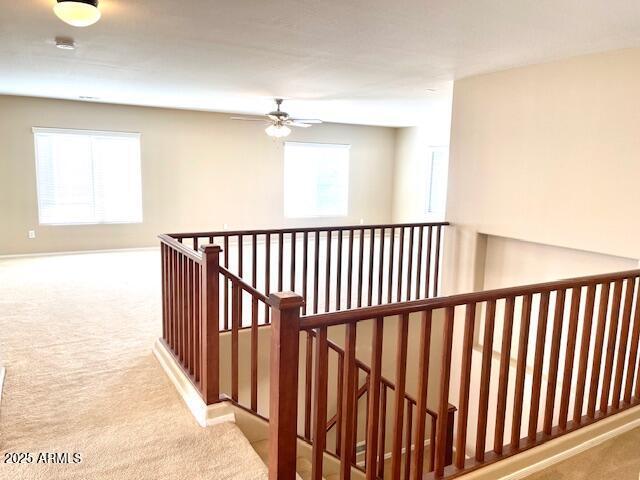 corridor featuring carpet and an upstairs landing