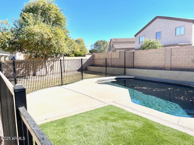 view of swimming pool with a patio and a yard